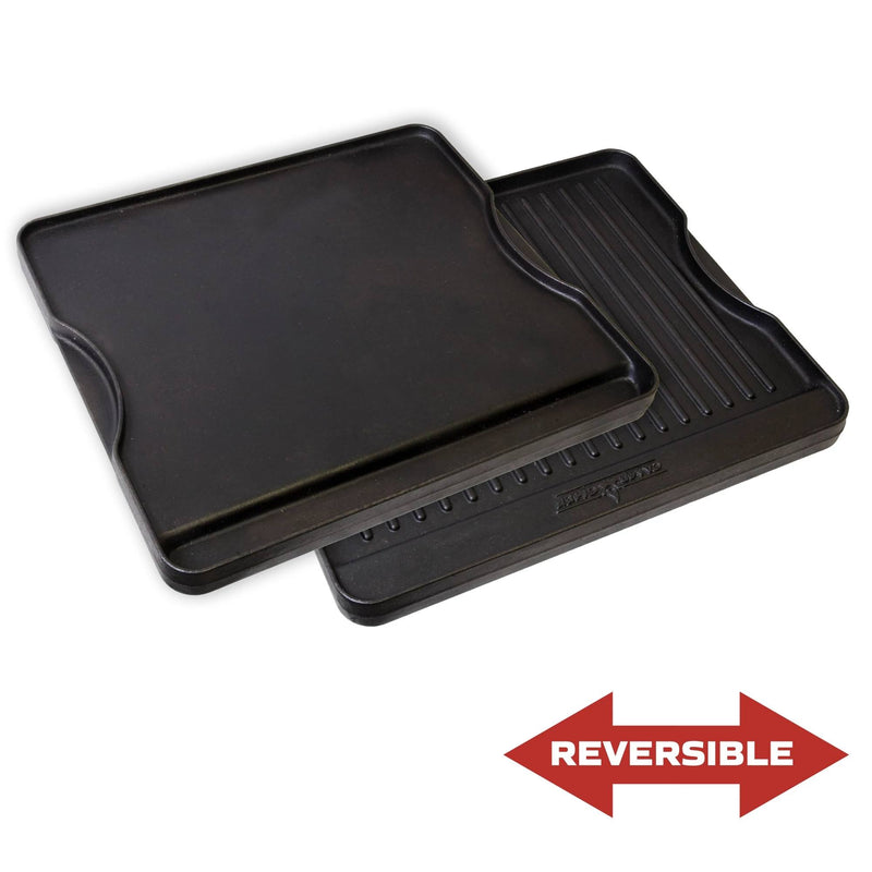 Load image into Gallery viewer, The Camp Chef Griddles 14 is a reversible black pan with one smooth side like a Flat Top Griddle and one ridged side for grilling, shown by a red double-headed arrow below to highlight its versatile design.
