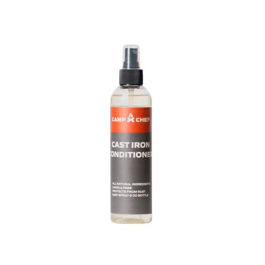 A clear 8 oz spray bottle labeled Camp Chef Cast Iron Conditioners with a black pump top features all-natural ingredients and protects cast iron from rust—perfect for Dutch oven conditioning.