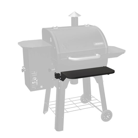The Camp Chef Pellet Grill Front Shelf, shown here in black and attached to the front of the grill for easy outdoor access, enhances convenience while grilling.