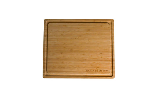 The Camp Chef Bamboo Cutting Board is square with a deep groove around the edge and features a 