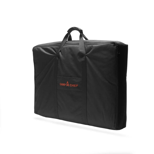 The Camp Chef Griddle Bag FTG600P is a black rectangular carry bag with two handles, zippered closure, and a front pocket featuring the Camp Chef logo in red—designed for convenient transport of your Portable Flat Top Grill 600 griddle.