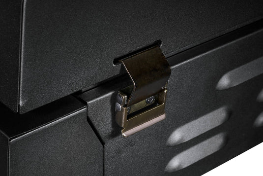 A close-up of the sturdy metal latch on the Camp Chef Gridiron Gameday secures the edge of its black, textured box—ideal for keeping your outdoor cooking system safely closed during travel or tailgates.