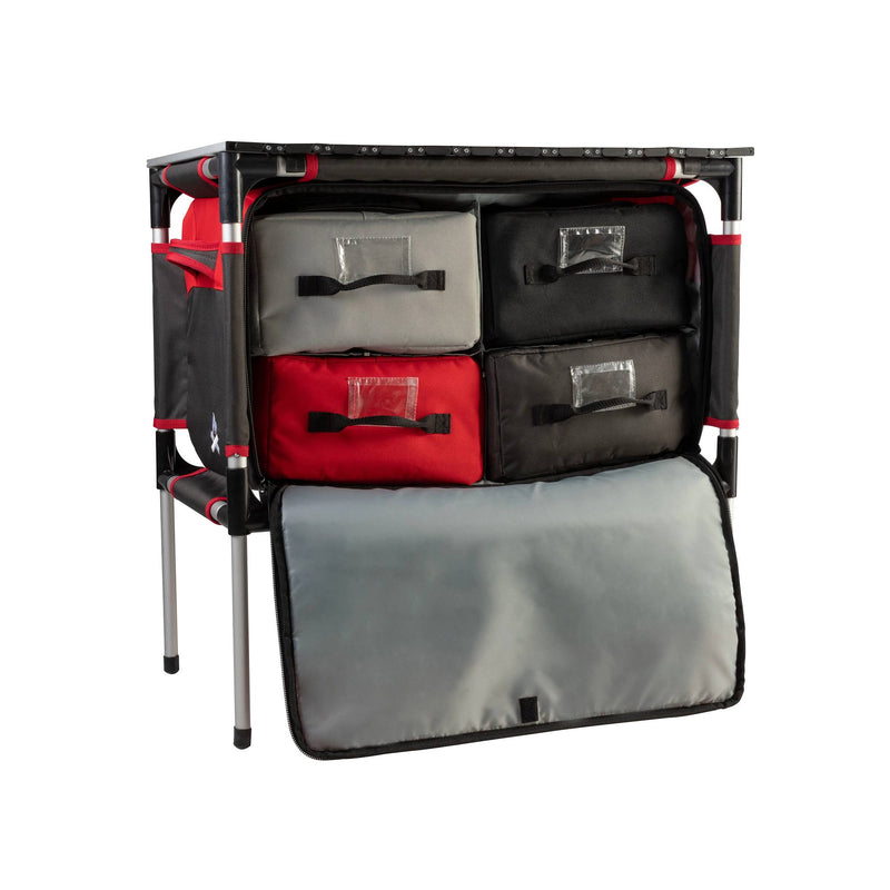Load image into Gallery viewer, The Camp Chef Sherpa Table &amp; Organizer features four fabric drawers in red, black, and gray, a sturdy metal frame, and a fold-down front cover—ideal for keeping your gear organized at campsites or outdoor cooking stations.
