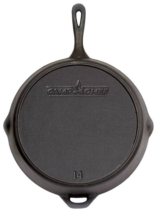 The Camp Chef Cast Iron Skillet is shown from above, featuring a black seasoned finish, a handle with an opposite loop handle, two side spouts, and the bottom displays the Camp Chef logo, flame icon, and number 14.