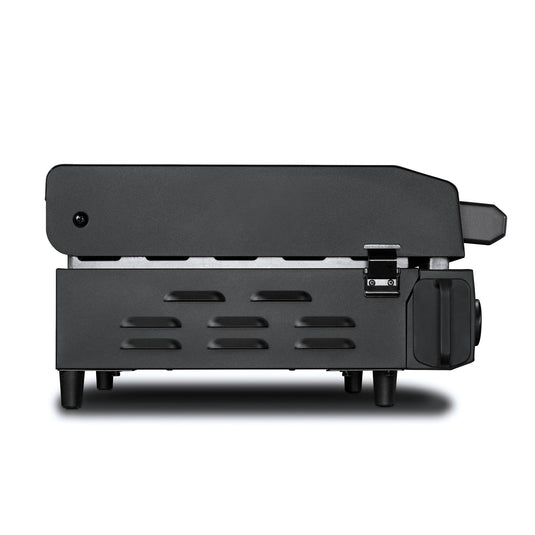 Side view of the Camp Chef Gridiron Gameday, a black electric kitchen appliance with lower vents and a right-side latch, possibly used as a panini press or portable grill, displayed against a white background.