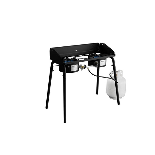 The Camp Chef Explorer, a black metal cooking system with two burners and a propane tank, stands on four legs against a white background—ideal for outdoor cooking.