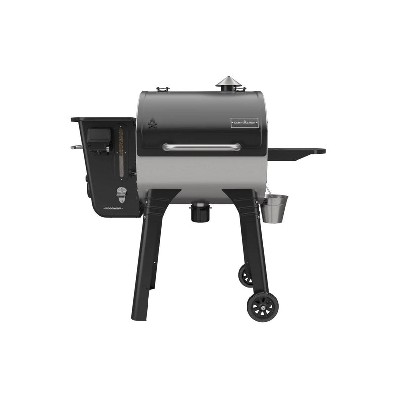Load image into Gallery viewer, The Camp Chef Woodwind 24 is a black and silver pellet grill with a barrel-shaped body, WIFI controller on the left panel, chimney on top, right-side shelf, and two wheels for easy mobility.
