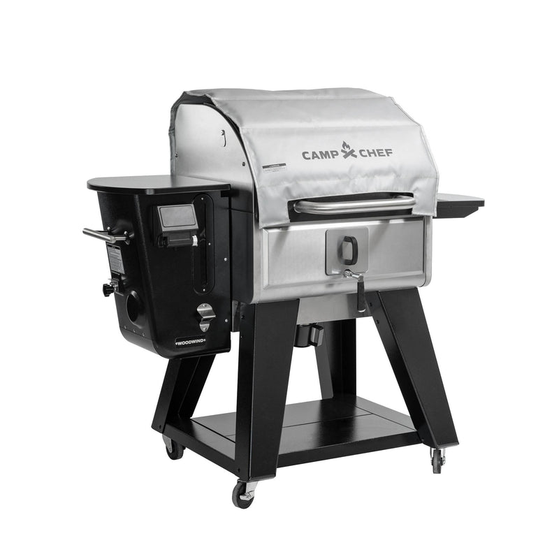 Load image into Gallery viewer, The Camp Chef Woodwind grill and smoker features stainless steel, wheels, a digital control panel, side shelf, and lower storage—compatible with the Camp Chef Woodwind Pro Blanket for fire-resistant protection.
