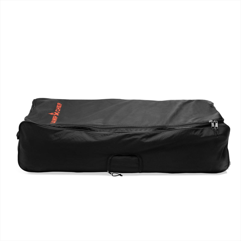Load image into Gallery viewer, A large, rectangular heavy-duty Camp Chef Stove System Roller Bag with a zippered top and handle, featuring the red Camp Chef logo on one corner, is shown on a white background.
