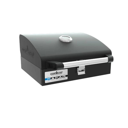 The Camp Chef BBQ Grill Boxes 14 is a black, rectangular outdoor tabletop grill with a cast iron surface, silver handle, built-in lid thermometer, front logo and label, and a modern compact design for professional grilling.