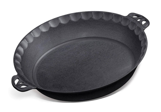 The Camp Chef Cast Iron Pie Pan, black with scalloped edges and two open handles, is designed for even heat distribution and a golden brown crust, shown on a white background.