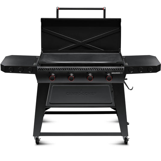 The Camp Chef Gridiron 36 is a black outdoor flat-top griddle grill with an open lid, four control knobs, side shelves, and wheels—perfect for large groups. It offers even heating across the surface and easy cleanup after every meal.