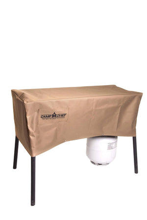 A weather-resistant Camp Chef 16-in Stove Cover in brown protects a rectangular outdoor cooking system with four black legs and a white propane tank, shown against a white background.