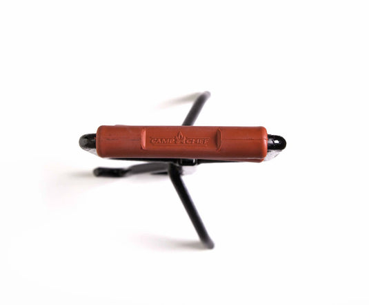The Camp Chef Dutch Oven Lid Lifter, featuring a black metal body with a brown branded handle and two prongs, is displayed against a white background with the handle facing forward.