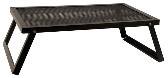 The Camp Chef Lumberjack Over Fire Grill 18”x36” is a black, rectangular heavy-duty portable grill with a mesh surface and folding legs, designed for outdoor cooking or use over a campfire.