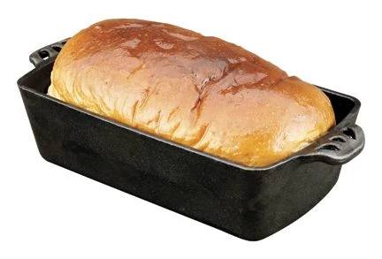 Load image into Gallery viewer, A golden-brown loaf rests in the Camp Chef Cast Iron Bread Pan, which is pre-seasoned for even heat distribution, shown against a white background.
